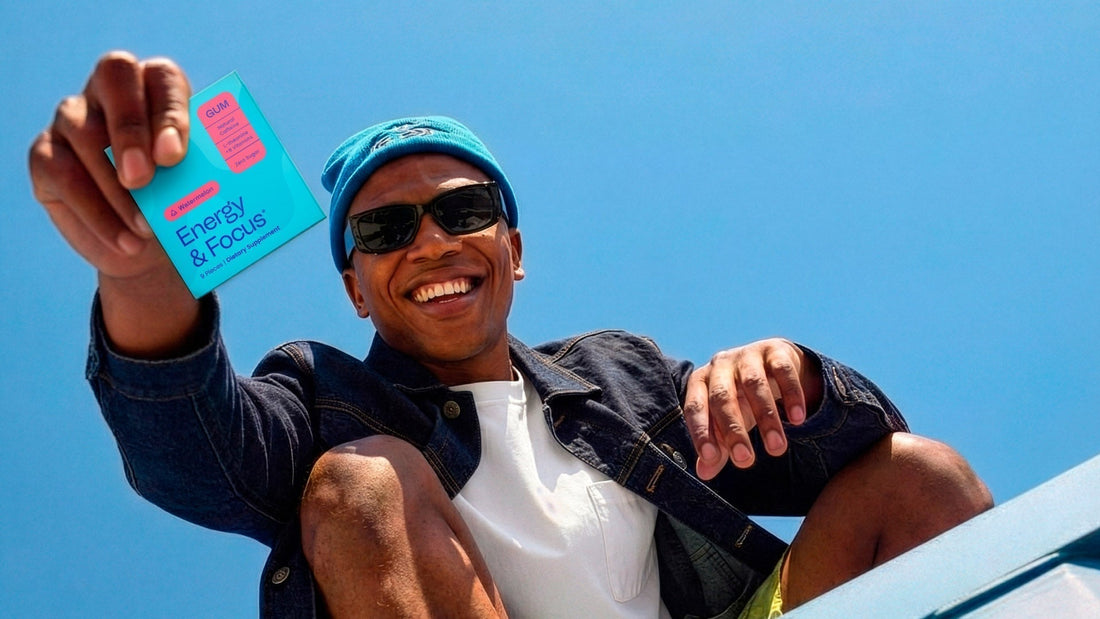 Man in sunglasses smiling holds a Neuro Energy & Focus gum Watermelon package