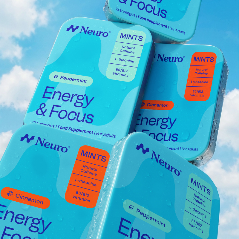Several Neuro Energy & Focus mint candy supplement boxes arranged in a fan-like stack against a blue sky with clouds. The boxes are light blue with darker blue graphics, white text, and orange accent labels reading Mints, Peppermint, and Cinnamon.